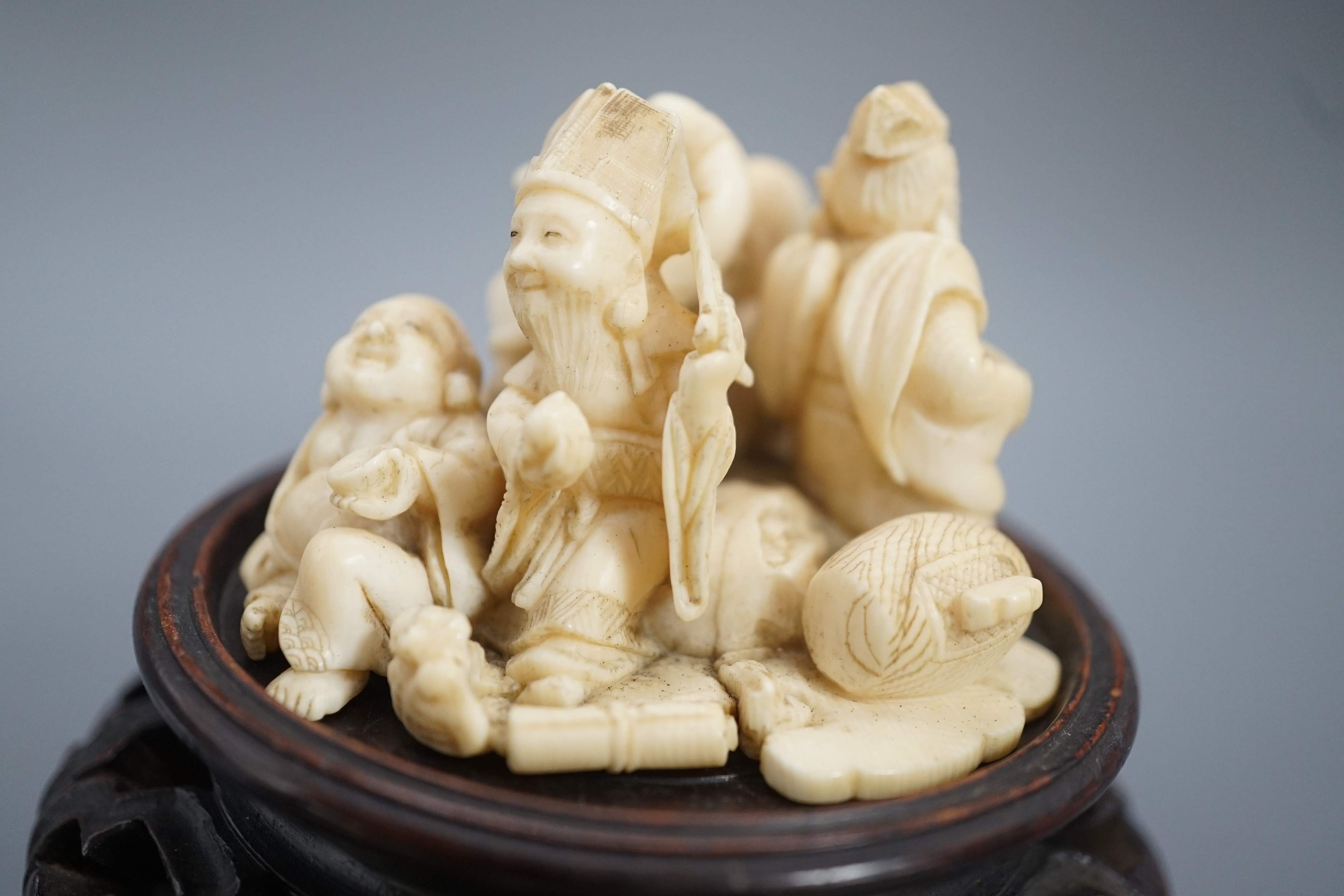 A Japanese ivory okimono of four of the Gods of Happiness, signed Gyokuzan, early 20th century, 6cm
